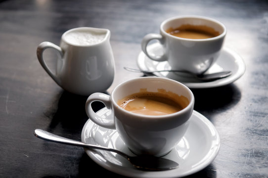 Two Coffee Cups On Table In Cafe