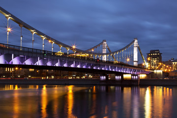 Fototapeta na wymiar Krymsky Bridge or Crimean Bridge at night is a steel suspension bridge in Moscow, Russia.