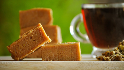 Energy bars in green nature background and a cup of tea, coffee