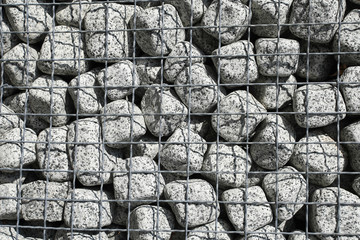 Granite cubes made of natural stone with a metal grid