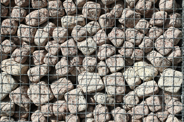 Granite cubes made of natural stone with a metal grid