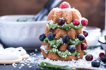 Decorating Christmas tree cake with fruits