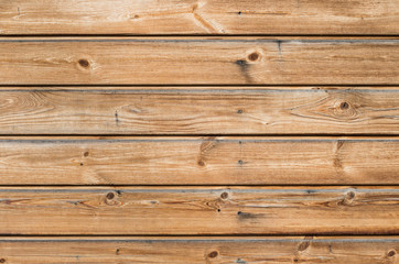 Obraz na płótnie Canvas Larch wooden planks on the building facade covered with preventive impregnation