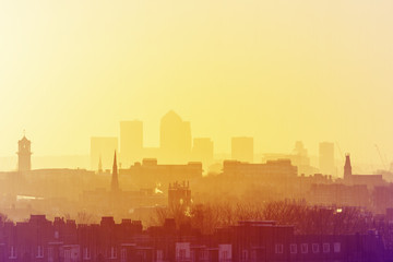 Fototapeta na wymiar Lord Kelvin Retro Photo Filter - London Cityscape at Sunrise with early morning mist from Hampstead Heath looking towards Canary Wharf, England, UK