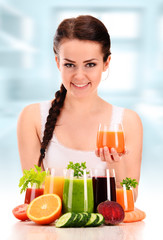 Young woman with variety of vegetable and fruit juices