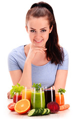 Young woman with variety of vegetable and fruit juices