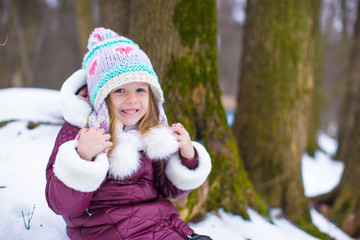 Adorable little girl having fun during winter vacation