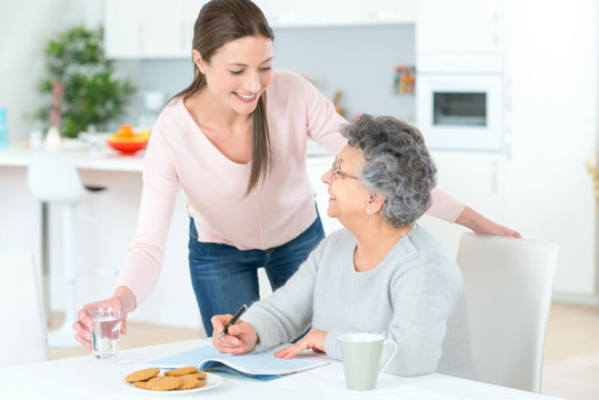 Carer Helping Woman At Home