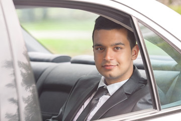 Young businessman traveling to work by taxi