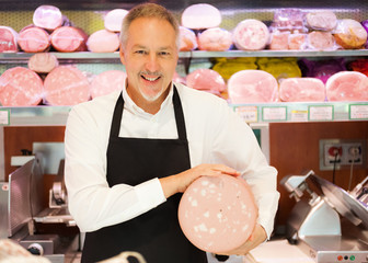 Shopkeeper showing italian bologna © Minerva Studio