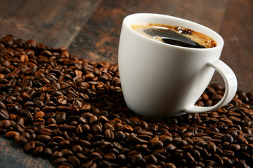 Composition with white cup and coffee beans