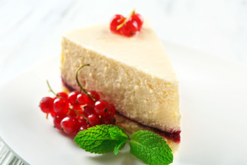 Delicious cheesecake with berries on table close up