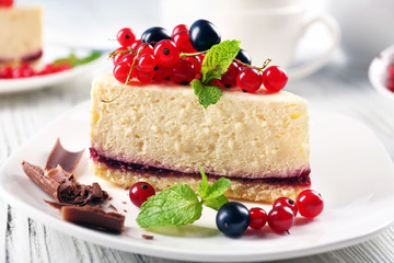 Delicious cheesecake with berries on table close up