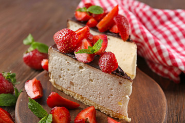 Delicious cheesecake with berries on table close up