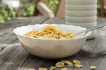 bottle of milk and bowl of cornflakes