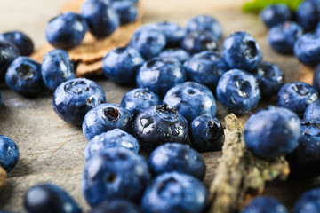 Tasty ripe blueberries on wooden table close up