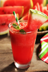 Glass of watermelon juice on wooden table, closeup