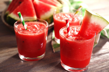 Glasses of watermelon juice on wooden table, closeup