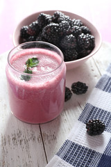 Delicious berry smoothie with blackberries on table close up