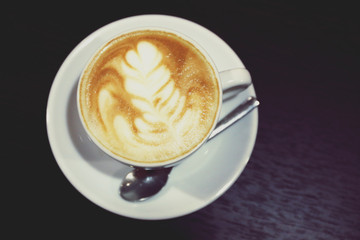 Cup of coffee on wooden table close up
