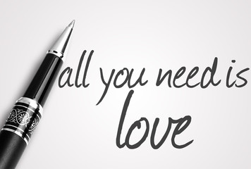 pen writes all you need is love on white blank paper