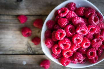 Fresh raspberries on rustic wooden background