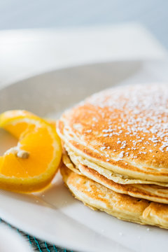 Pancakes with sugar powder on white plate