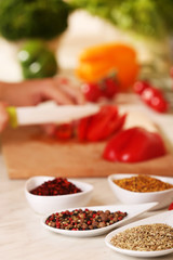 Variety of spices in ceramic containers on the kitchen table