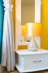 Interior Design: Modern Bedroom, Bedside cabinet. / Interior Design: Modern Bedroom, White Wooden bedside table and reading lamp.