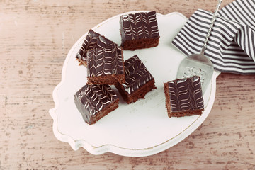 Served table with chocolate cakes on wooden background close-up