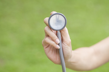 Fototapeta premium hand with stethoscope listening something