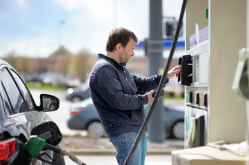Man filling gasoline fuel