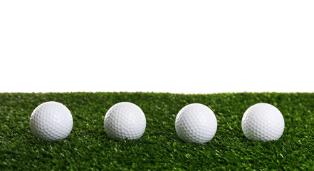 Golf balls on grass isolated on white