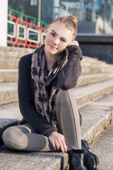 Smiling Cute Teenage Blond Girl Posing Outside on Stairs.