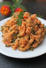 Couscous salad with tomatoes, greens and lemon juice and olive oil, Turkish national dish kysyr