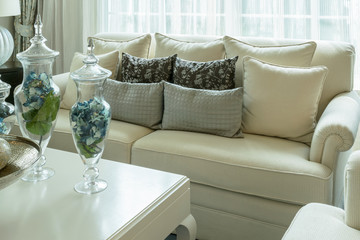 white and gray decorative pillows on a casual sofa in the living