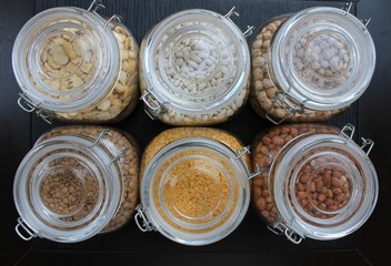 Grains and beans in glass jars in the kitchen