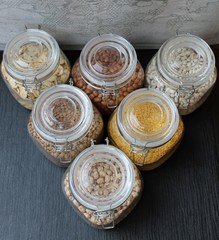 Grains and beans in glass jars in the kitchen