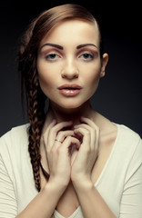 portrait of beautiful young blonde woman with creative braids ha