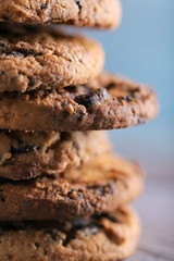 Close up focus view on cookies with chocolate crumbs on wooden table against blurred blue background