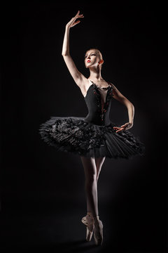 Slim ballerina in a black corset and tutu.