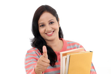 Cheerful female student with thumbs up gesture