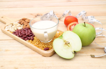 Healthy fresh vegetables salad preparation with kitchen utensils on a table and nutrition concepts