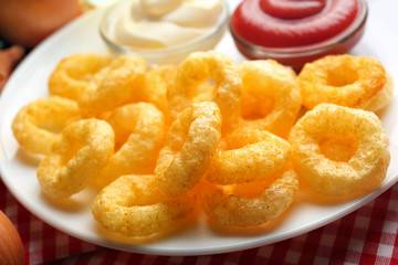 Chips rings with sauce on plate