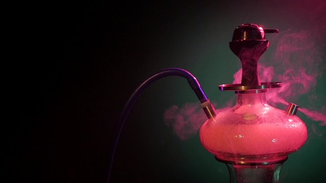 Purple hookah smoke on black background. slow motion