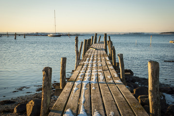 Fototapeta premium Wooden pier in snow at the sea, Norway