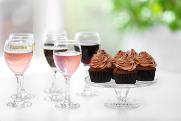 Tasting of wine and chocolate cupcakes, close up