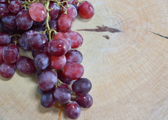 red grape on wooden chop block