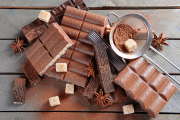 Chocolate sweets with powder on wooden background