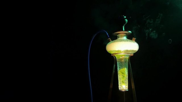 Colored yellow hookah with the smoke, slow motion
